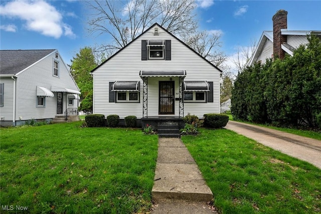 bungalow-style home with a front yard