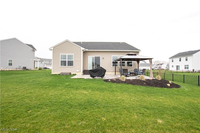 rear view of house featuring a lawn, a patio, a gazebo, and fence