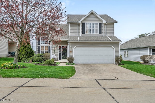 traditional-style home with a shingled roof, an attached garage, concrete driveway, and a front lawn