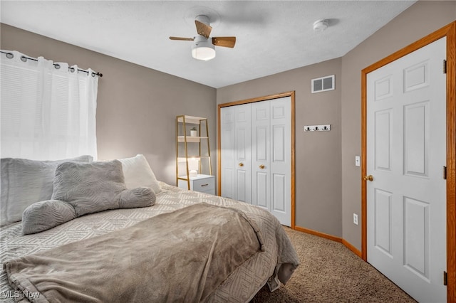 bedroom featuring carpet flooring, ceiling fan, baseboards, visible vents, and a closet