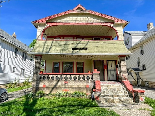 victorian house with a porch and a balcony