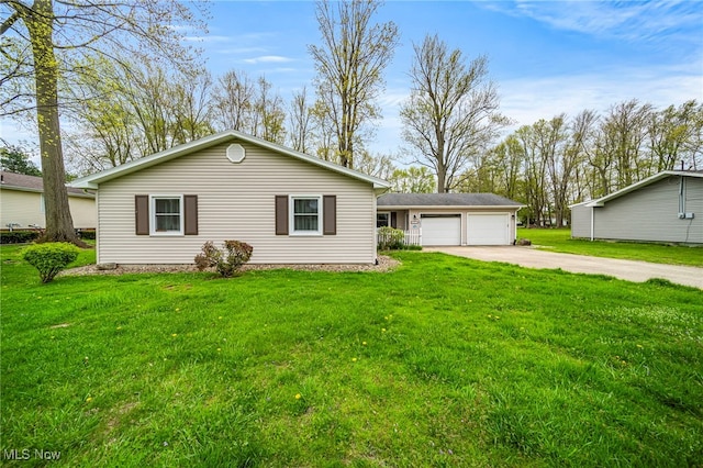 ranch-style house with an outdoor structure, a garage, a front lawn, and driveway