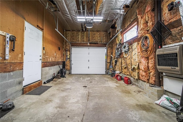 garage featuring heating unit and a garage door opener