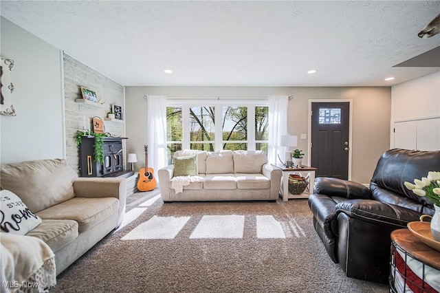 living area featuring carpet floors, recessed lighting, and a textured ceiling