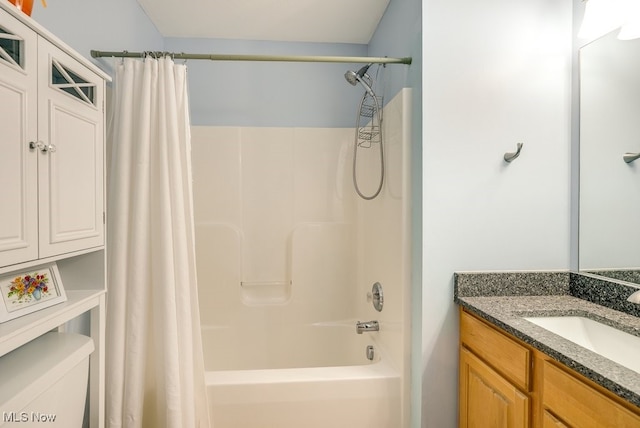 bathroom featuring toilet, shower / bathtub combination with curtain, and vanity