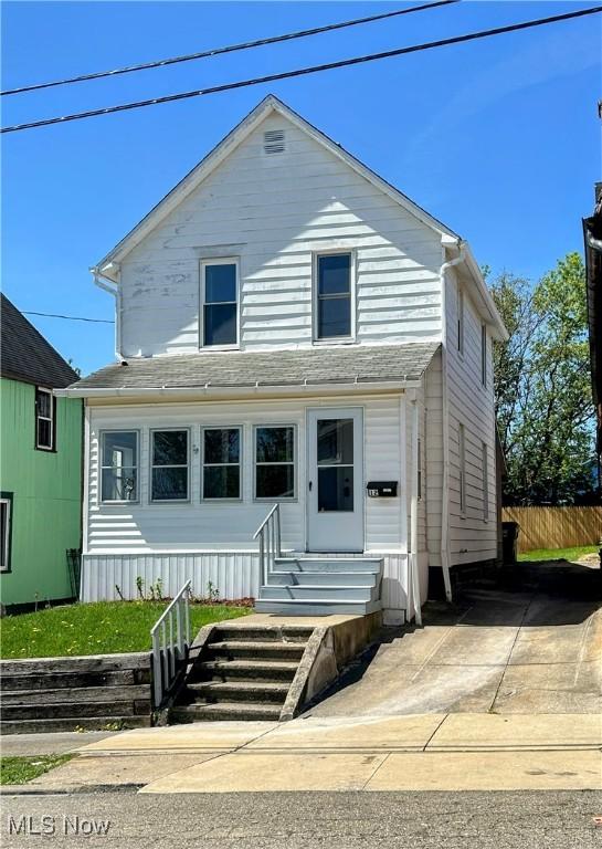 view of front of house with entry steps and fence