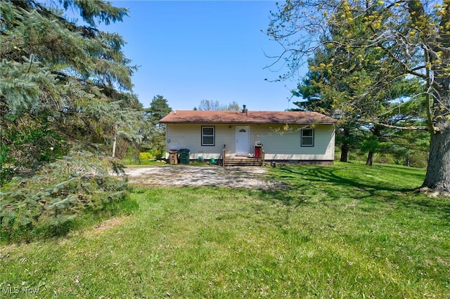 back of property featuring a lawn
