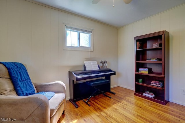 living area with ceiling fan and light wood-type flooring