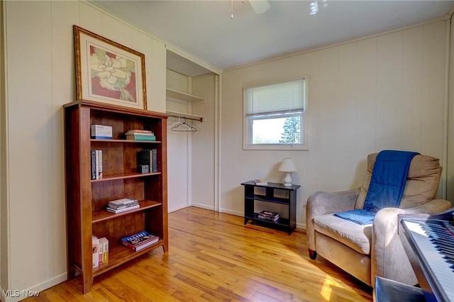 living area featuring a ceiling fan and light wood finished floors