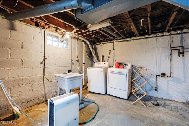 basement featuring a sink and washer and clothes dryer