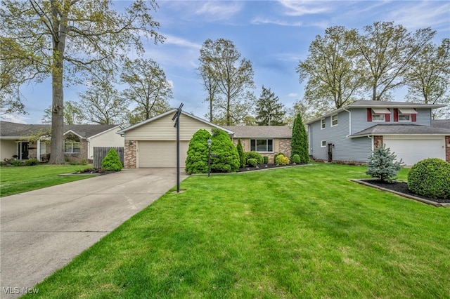 view of front of property with an attached garage, concrete driveway, a front yard, and brick siding