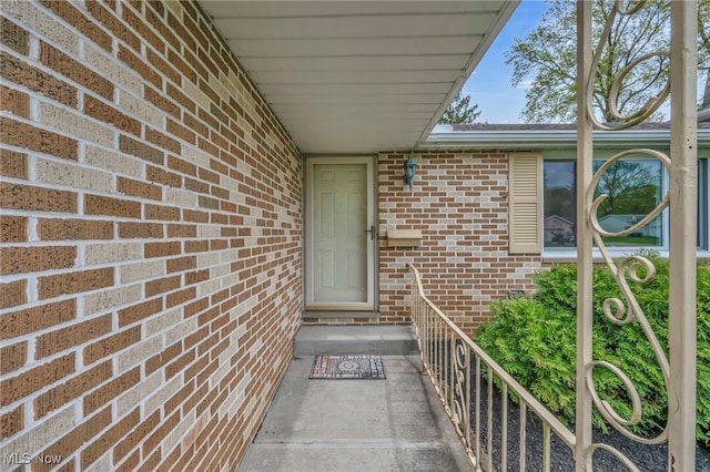 view of exterior entry with brick siding