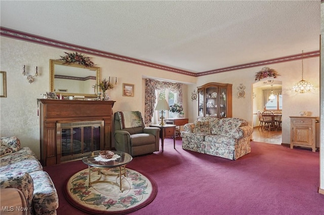 living room with ornamental molding, carpet flooring, and a textured ceiling
