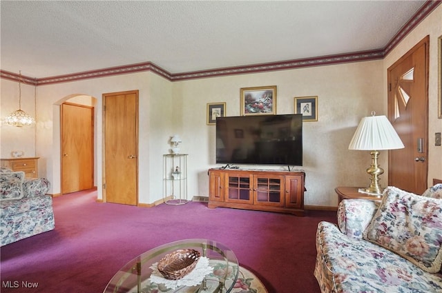 carpeted living area with arched walkways, ornamental molding, baseboards, and a textured ceiling