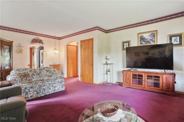 living area featuring carpet floors, arched walkways, and crown molding