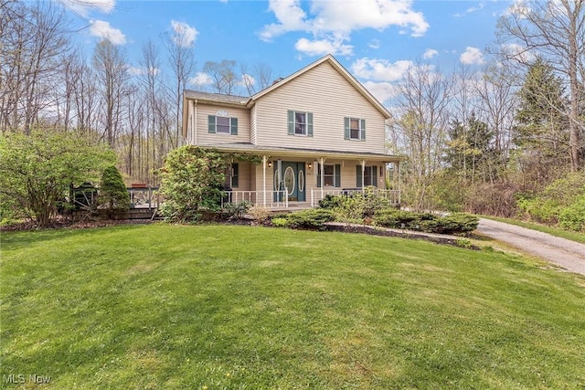 view of front of house with covered porch and a front lawn