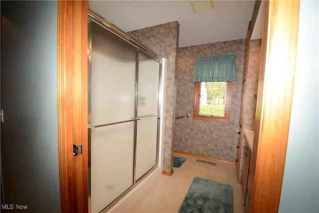 bathroom featuring wallpapered walls, visible vents, a shower stall, and baseboards
