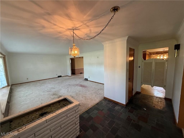 interior space featuring crown molding, baseboards, dark colored carpet, and a chandelier
