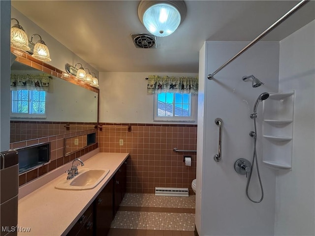 full bath featuring tile walls, tile patterned flooring, walk in shower, and visible vents