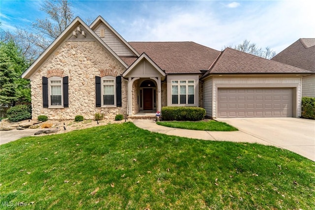 view of front facade with a garage, a front yard, stone siding, a shingled roof, and concrete driveway