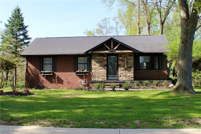 view of front of house featuring stone siding, brick siding, and a front yard