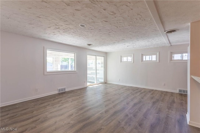 3050 Latimer Ave, Ashtabula, OH 44004 - empty room with dark wood-type flooring, baseboards, and a textured ceiling