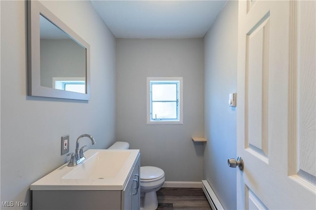 3050 Latimer Ave, Ashtabula, OH 44004 - bathroom with toilet, wood finished floors, vanity, a baseboard radiator, and baseboards