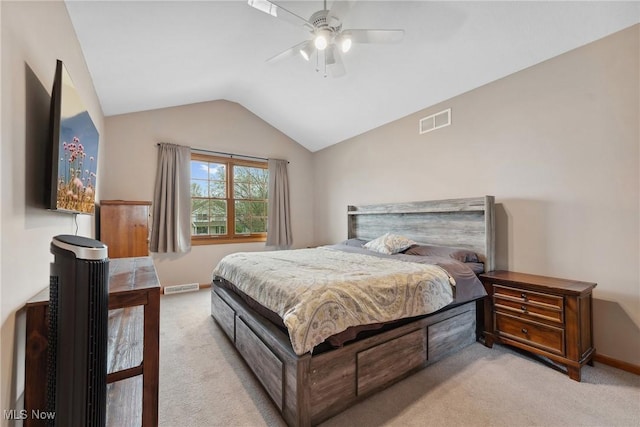bedroom featuring baseboards, visible vents, light carpet, and vaulted ceiling