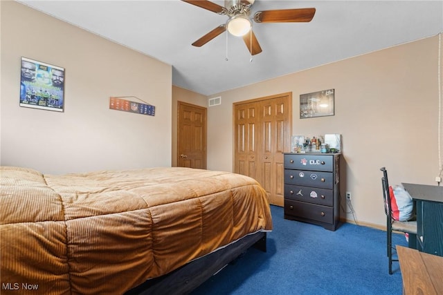 carpeted bedroom featuring a closet, a ceiling fan, and visible vents