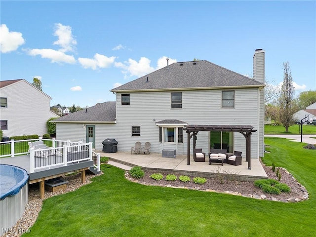 rear view of house featuring an outdoor living space, a chimney, a lawn, a wooden deck, and a pergola