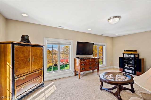 living area featuring recessed lighting, baseboards, light colored carpet, and visible vents