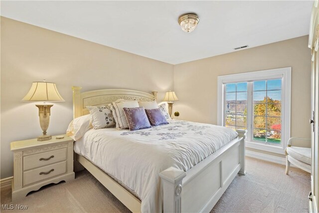 bedroom with light colored carpet, baseboards, and visible vents
