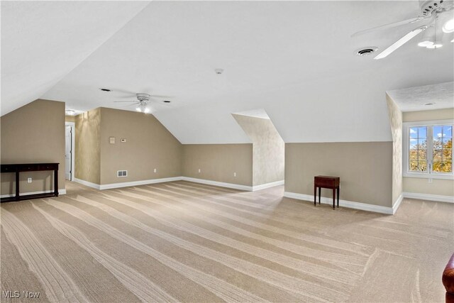 bonus room featuring ceiling fan, lofted ceiling, visible vents, and light colored carpet