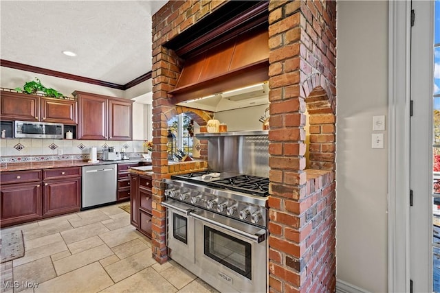 kitchen featuring crown molding, dark brown cabinets, open shelves, appliances with stainless steel finishes, and tasteful backsplash