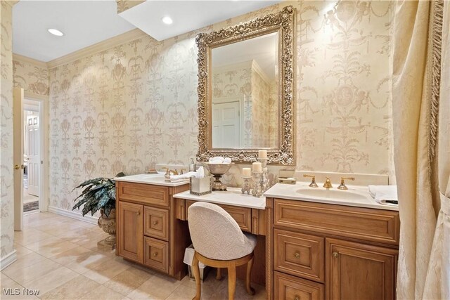 bathroom with vanity, tile patterned flooring, and wallpapered walls