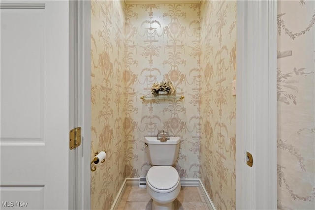 bathroom featuring baseboards, tile patterned floors, toilet, and wallpapered walls