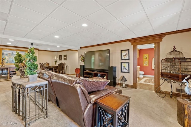 living area with crown molding, recessed lighting, baseboards, and light carpet