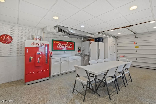 dining area with recessed lighting and a drop ceiling