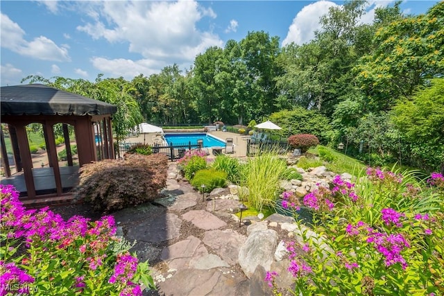 outdoor pool featuring fence and a gazebo