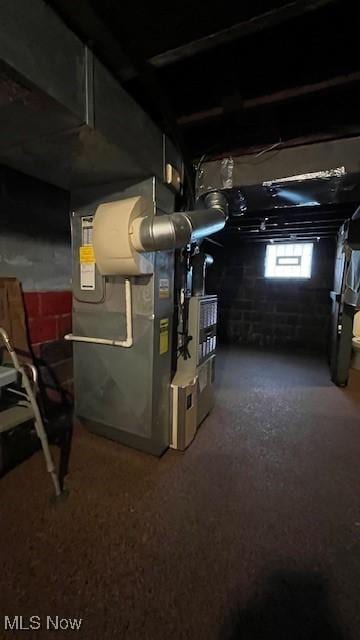basement featuring heating unit and carpet