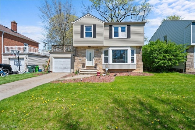 view of front of property featuring an attached garage, concrete driveway, a front yard, and stone siding