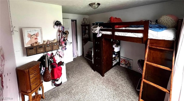 carpeted bedroom featuring a textured ceiling
