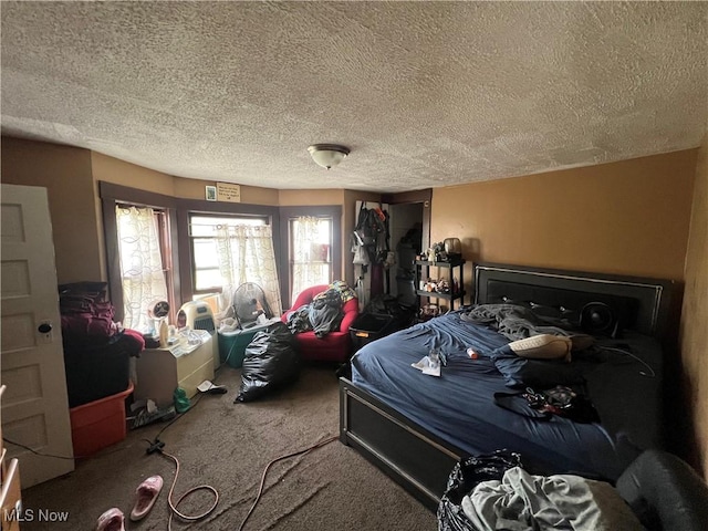 bedroom with a textured ceiling and carpet