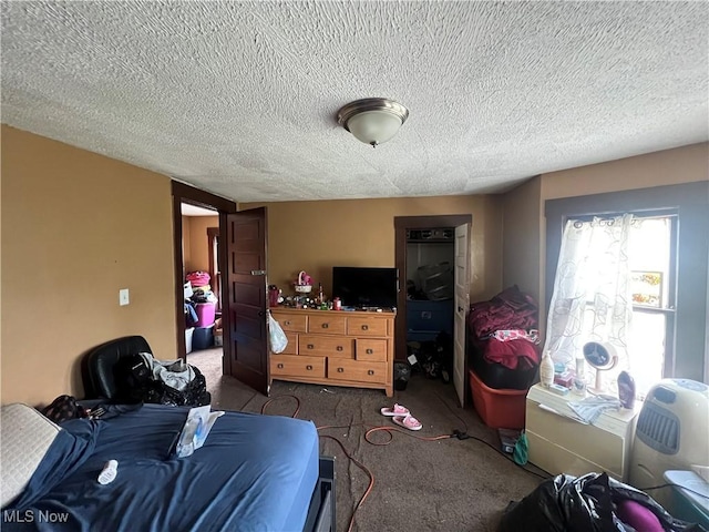carpeted bedroom with a textured ceiling