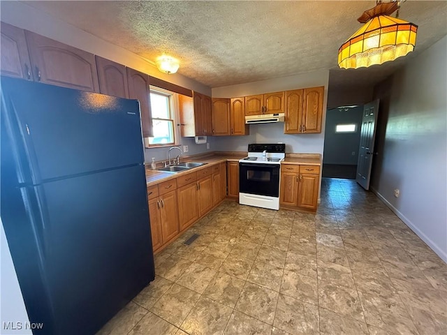 kitchen featuring freestanding refrigerator, range with electric stovetop, light countertops, under cabinet range hood, and a sink