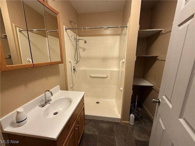 full bathroom with a stall shower and vanity