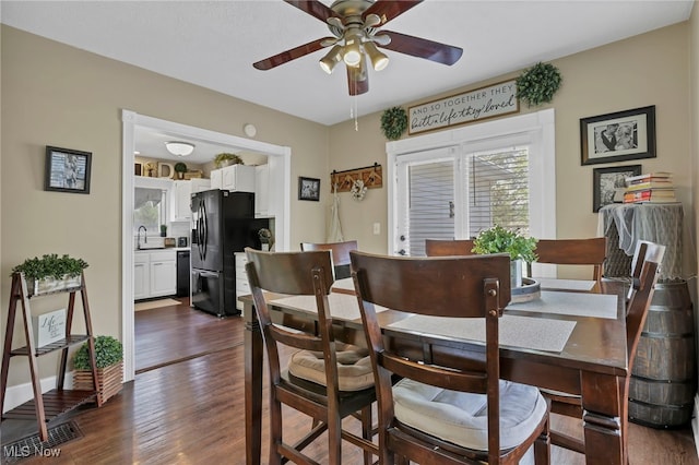 dining room with dark wood-style flooring, ceiling fan, and a wealth of natural light