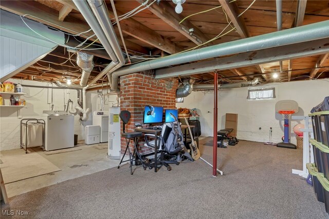below grade area featuring washer and clothes dryer and water heater
