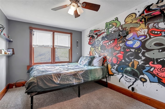 carpeted bedroom featuring baseboards, a ceiling fan, and a textured ceiling