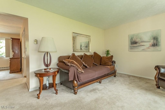 living room with baseboards, carpet, and a baseboard radiator